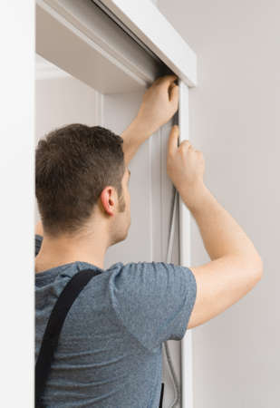 Handyman installing sliding door at home.の写真素材