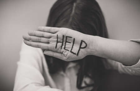 Depressed woman holding hand in front her face. Social problems concept.の写真素材