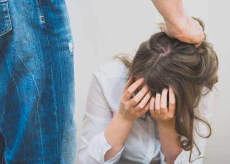 Home violence concept. Man pulling female's hairの写真素材