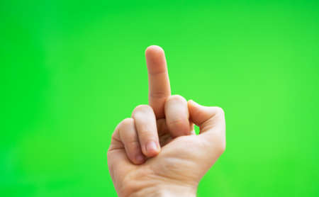 Male hand shows middle finger. Chroma key. Place for your advertisement.の写真素材