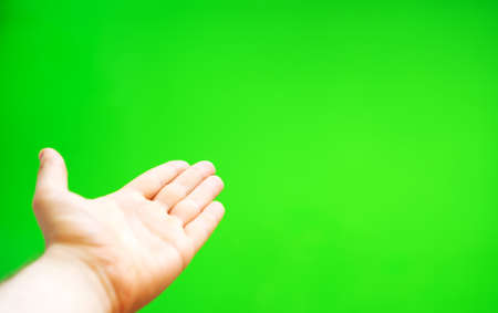 Male hand offers something. Chroma key. Place for your advertisement.の写真素材