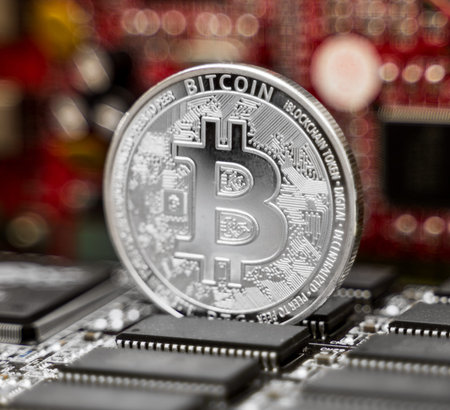 Silver bitcoin and video card. Cryptocurrency mining concept.