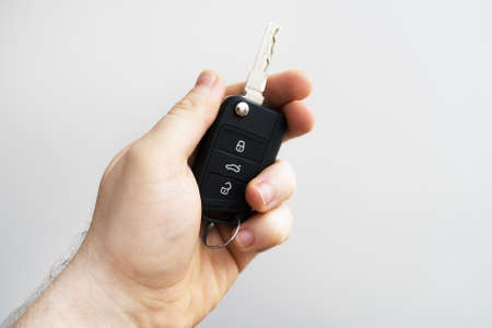 Male hand holding keys from car. Place for text.の写真素材