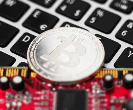 Silver bitcoin and video card. Cryptocurrency mining concept.の写真素材