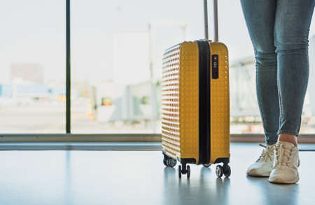 Woman with luggage in the airport.の写真素材
