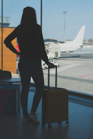 Young woman with luggage in the airport.の写真素材