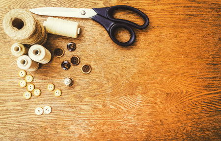 Sewing concept. Scissors, threads and buttons.