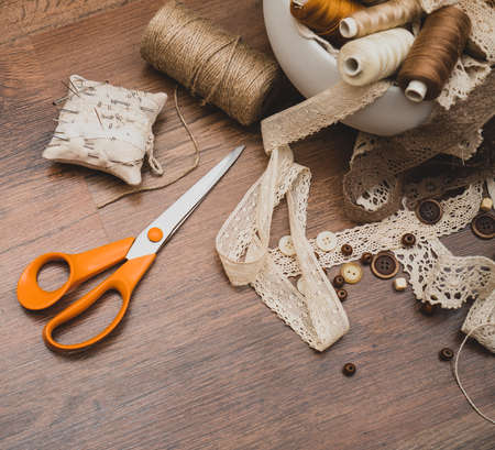 Sewing concept. Scissors, thread spools, buttons and sewing needles.の写真素材