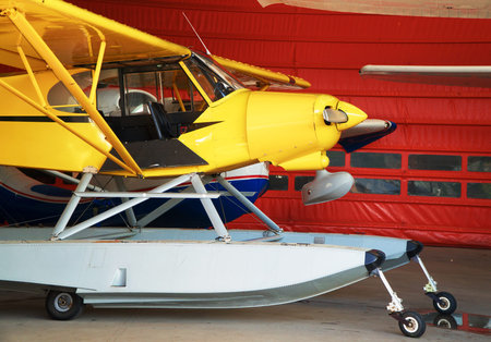 Close-up view of floatplanes (seaplanes) standing in hangar.