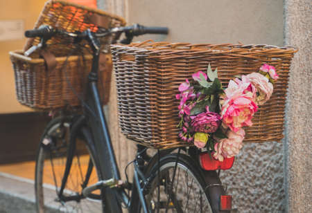 Retro bicycle with baskets parked near the wall.の写真素材