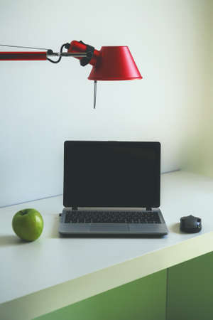 Personal computer standing on the table in a hotel room.の写真素材