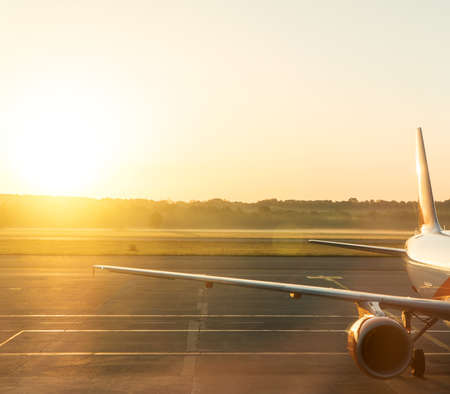 Part of airplane on the runway at sunset.の写真素材