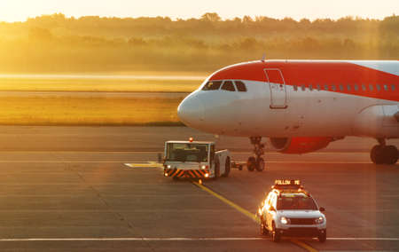 TUG Pushback tractor with Aircraft on the runway in airport.の写真素材