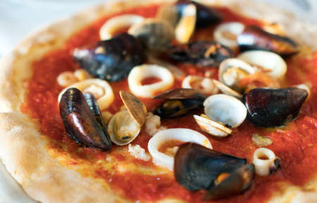 Italian pizza with seafood. Squids, mussels and shrimps.の写真素材