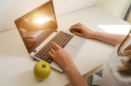 Woman working on a computer in a hotel.