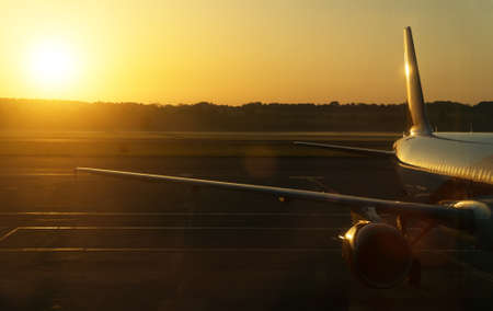 Part of airplane on the runway at sunset.の写真素材