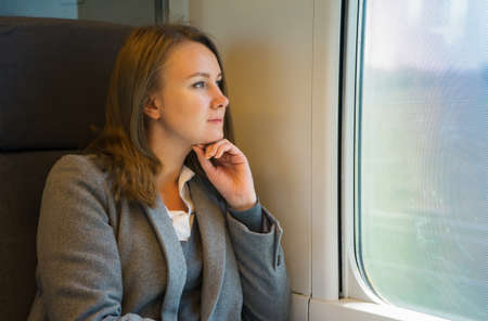 Pretty business woman travels by train.の写真素材