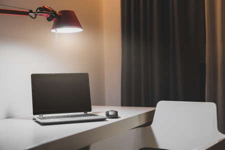 Personal computer standing on the table at late evening.の写真素材