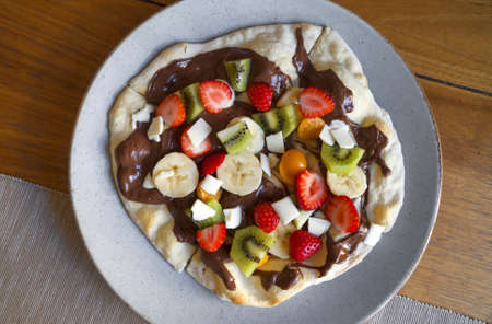 Sweet pizza made of fruits and chocolate spread.の写真素材