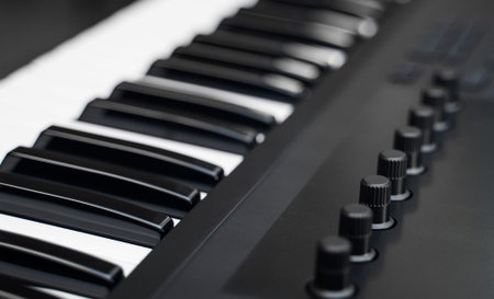 Professional midi keyboard synthesizer with knobs and controllers.