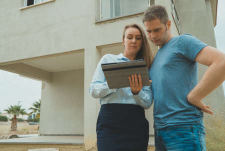 Real estate agent shows the development to his client.の写真素材