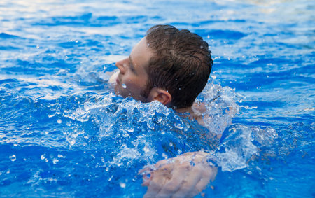 Man swimming in outdoor swimming pool. Sport concept.
