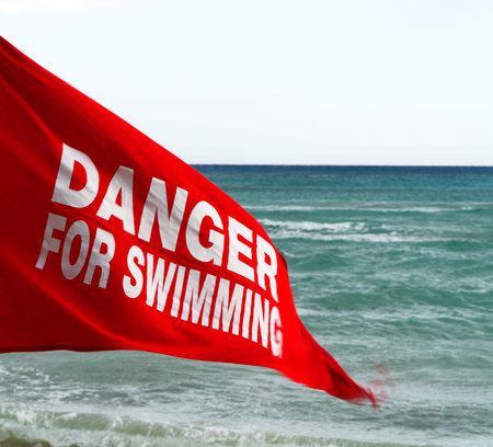 Danger for swimming red flag on the beach.