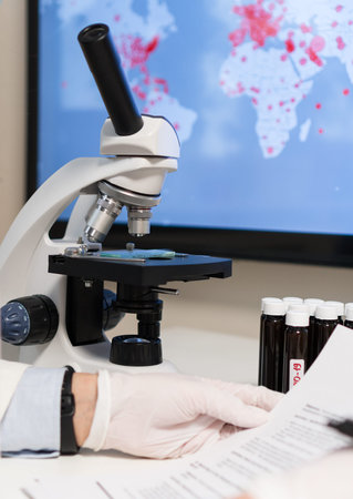Doctor reads the latest information about coronavirus. Map with infections on the background.