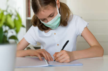 Little girl doing school homework during quarantine.の写真素材