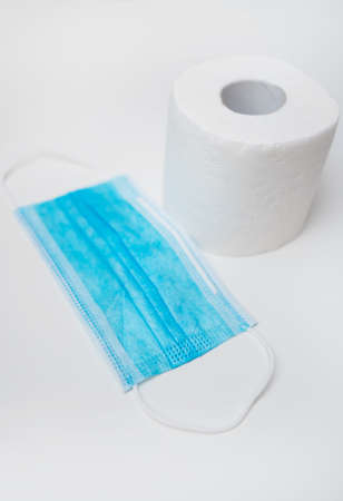 Toilet paper and medical mask. Coronavirus pandemic concept.の写真素材
