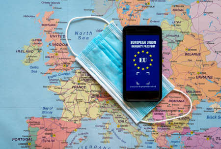 Immunity passport app and medical mask on Europe map. Travel during Covid-19 concept.の写真素材
