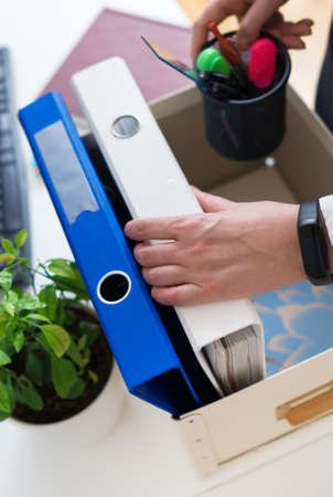 Businesswoman holding cardboard box with office stuff. Resignation concept.の写真素材