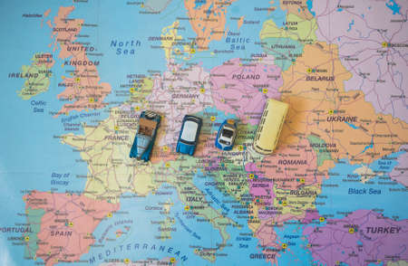 Set of small toy retro cars on the Europe map. Travel by car concept.の写真素材