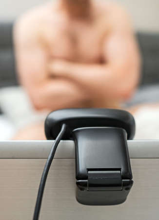 Man working as webcam model. Posing in front of camera.の写真素材