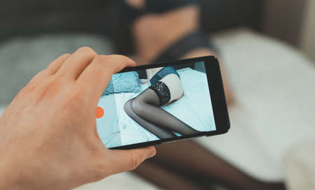 Man recording home video of his girlfriend.の写真素材