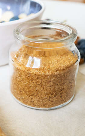 Brown sugar in the glass jar. Close-up view.の写真素材