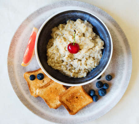 Healthy breakfast. Oat Flakes Porridge with toasts.の写真素材
