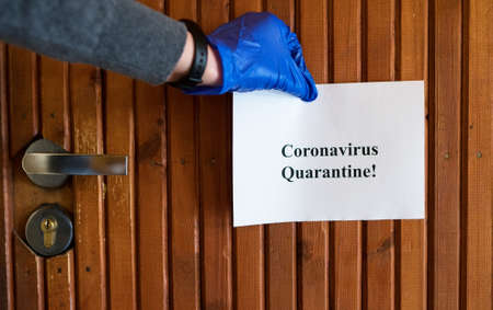 Coronavirus quarantine sign on the apartment door.の写真素材
