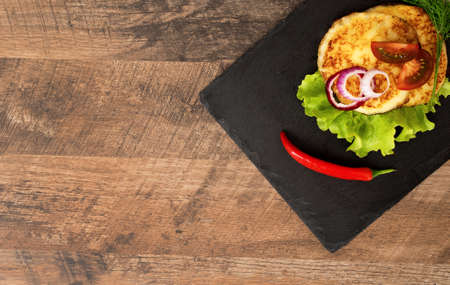 Grilled cheese with vegetables on the plate.の写真素材