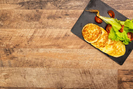 Grilled cheese with vegetables on the plate.の写真素材