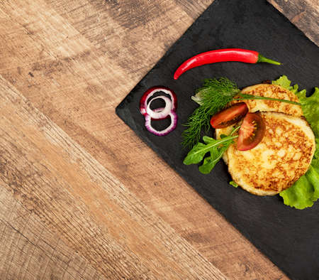 Grilled cheese with vegetables on the plate.の写真素材