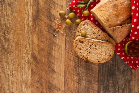 Fresh sliced bread and olive oil on the table.