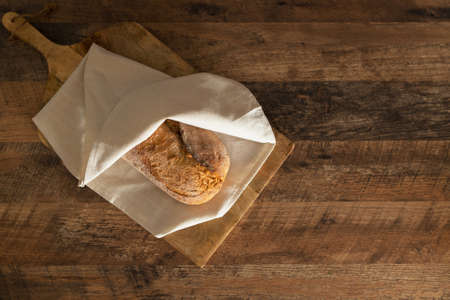 Freshly baked bread wrapped in a towel.の写真素材