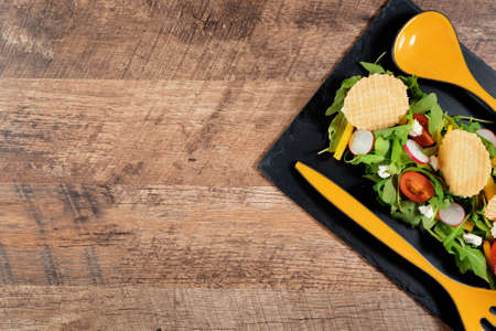 Fresh salad of arugula, pepper, radish, tomato and chips.の写真素材