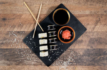 Sushi roll set on the black plate. Japanese food. Top view.の写真素材