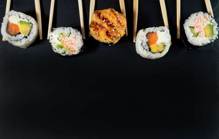 Sushi roll set with chopsticks. Place for your text or logo.の写真素材
