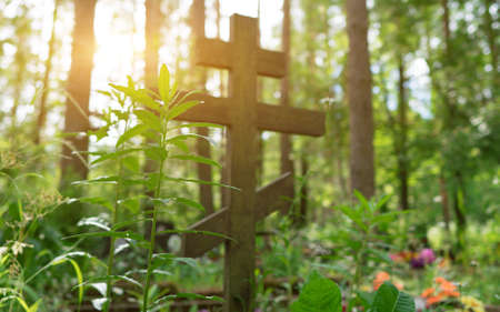 Old forgotten grave in the forest cemetery.の写真素材