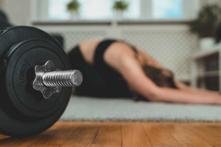 Woman practicing yoga. Home fitness training concept.の写真素材