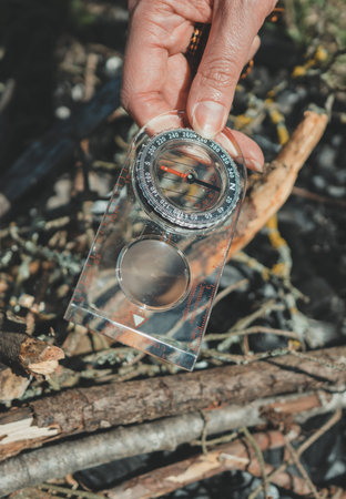 Woman uses a magnifying glass to burn a bonfire.