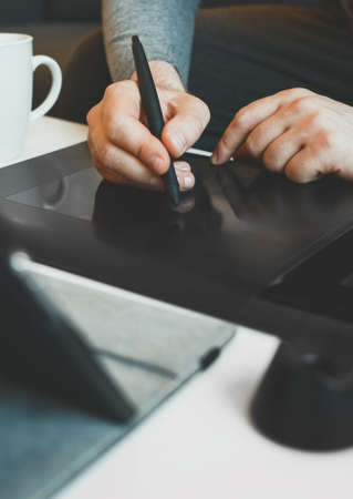 Graphic designer using electronic drawing tablet at home.の写真素材